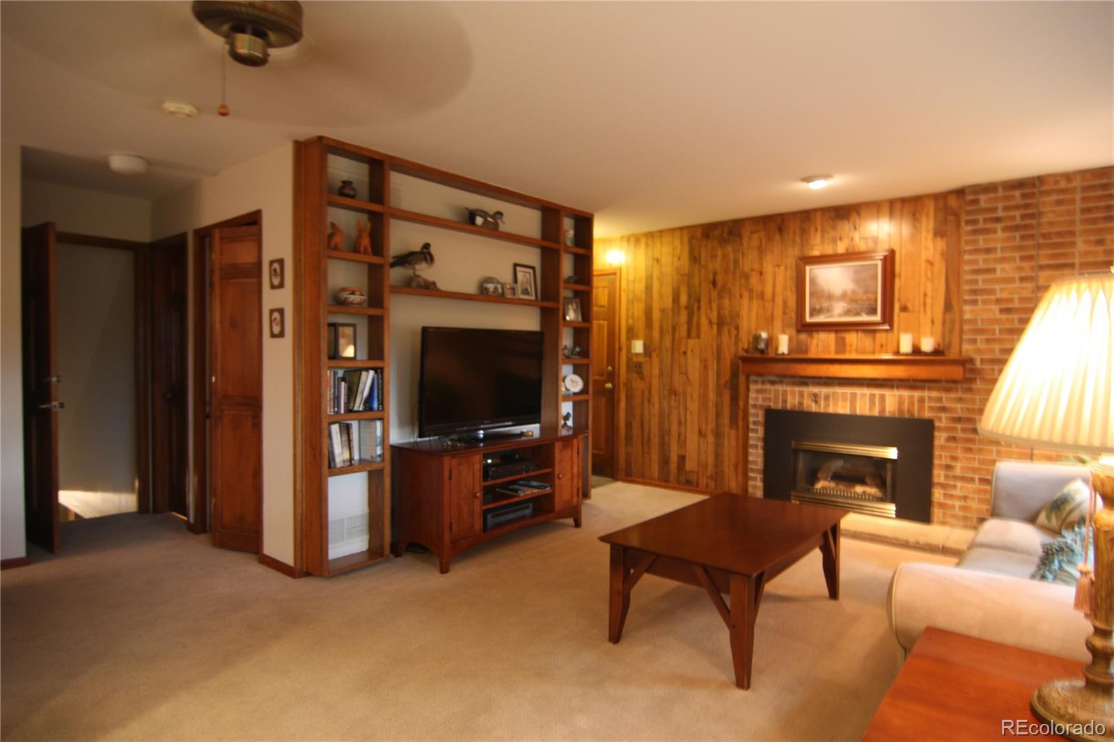 8435 Sweet Water Road Lone Tree, CO 80124 - Photo 5 of 24 a living room with furniture and a fireplace