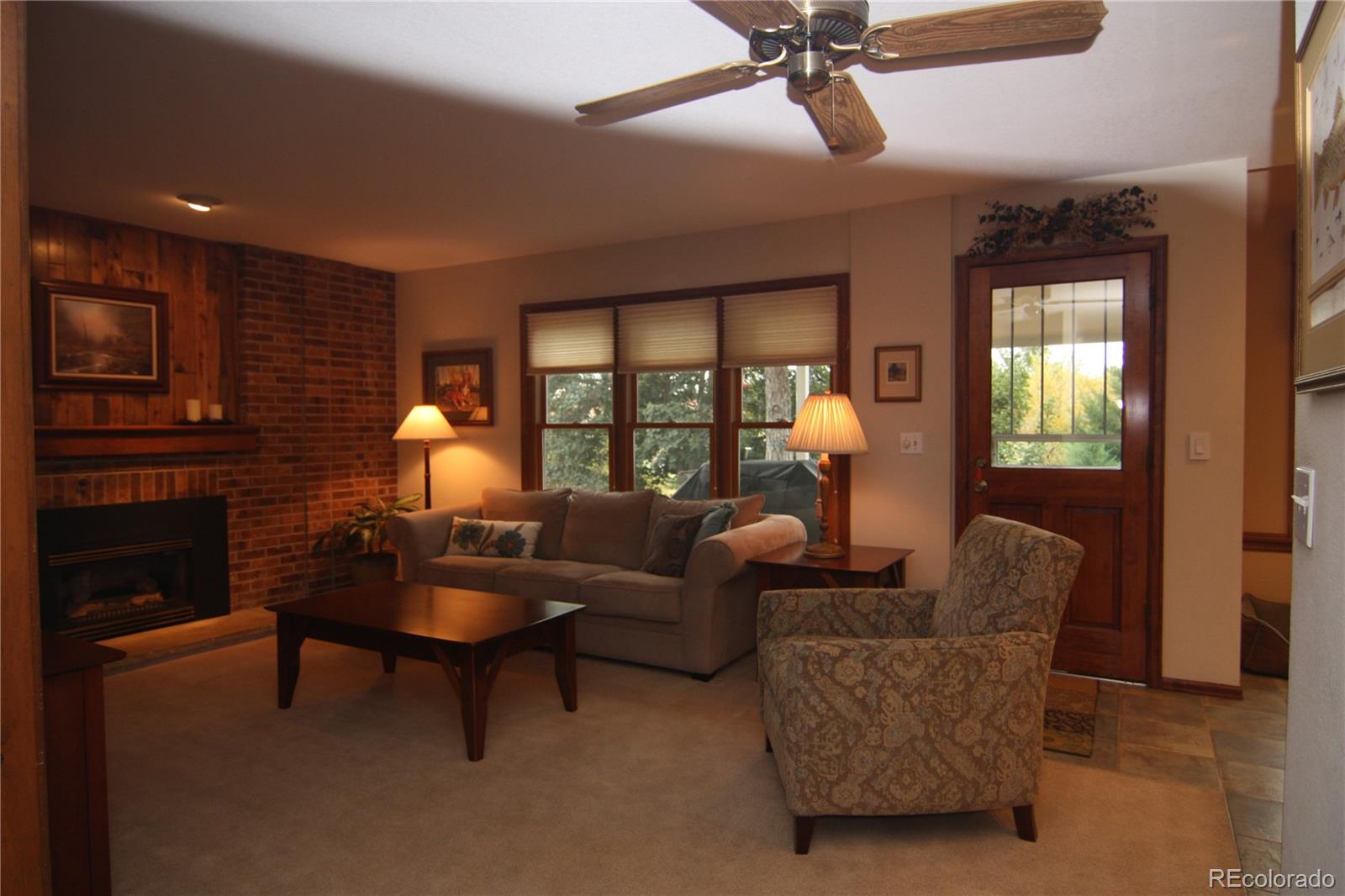 8435 Sweet Water Road Lone Tree, CO 80124 - Photo 6 of 24 a living room with furniture a ceiling fan and a window