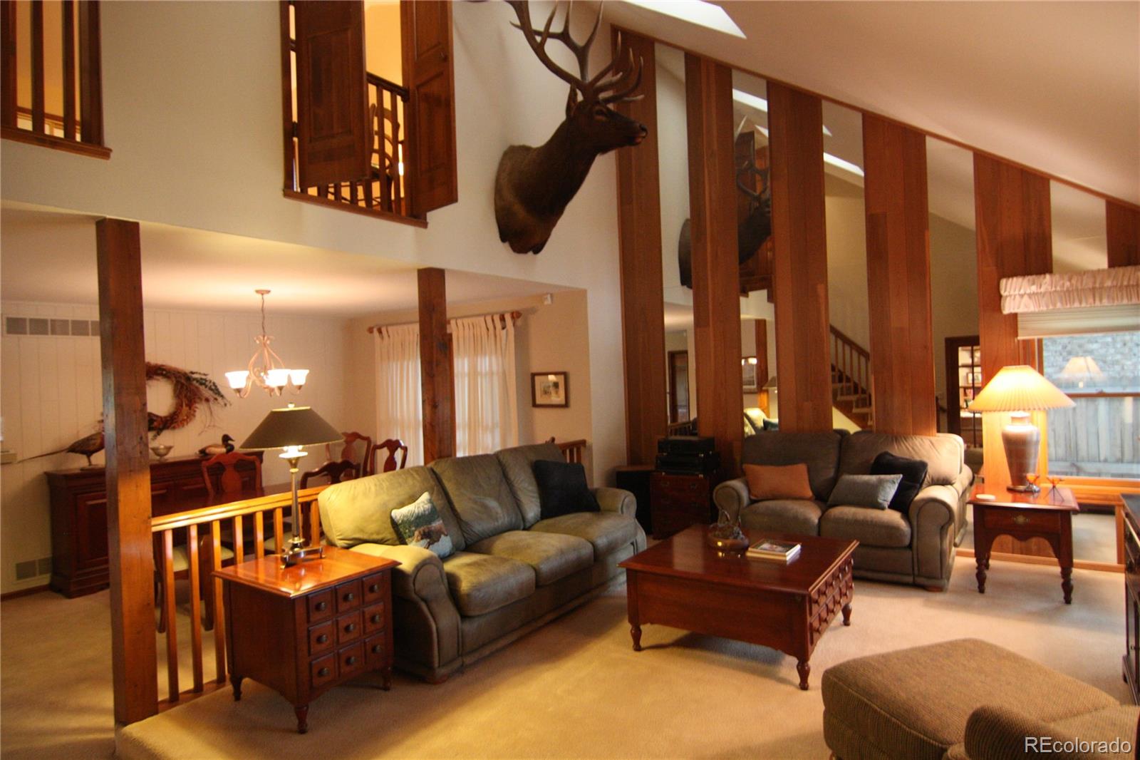 8435 Sweet Water Road Lone Tree, CO 80124 - Photo 10 of 24 a living room with furniture a lamp and a floor to ceiling window
