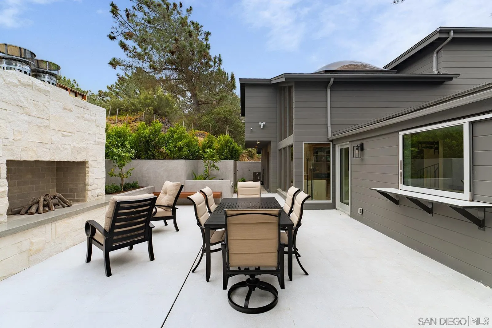 390 Hidden Pines Road Del Mar, CA 92014 - Photo 22 of 46 a view of a patio with table and chairs and a barbeque