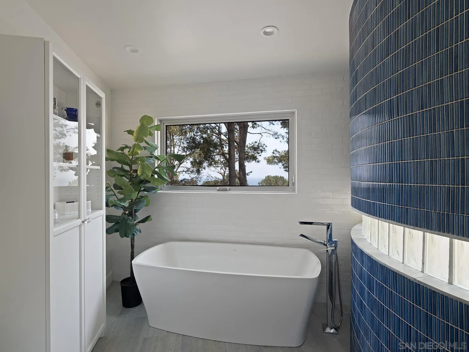 390 Hidden Pines Road Del Mar, CA 92014 - Photo 40 of 46 a white bath tub sitting in a bathroom next to a window