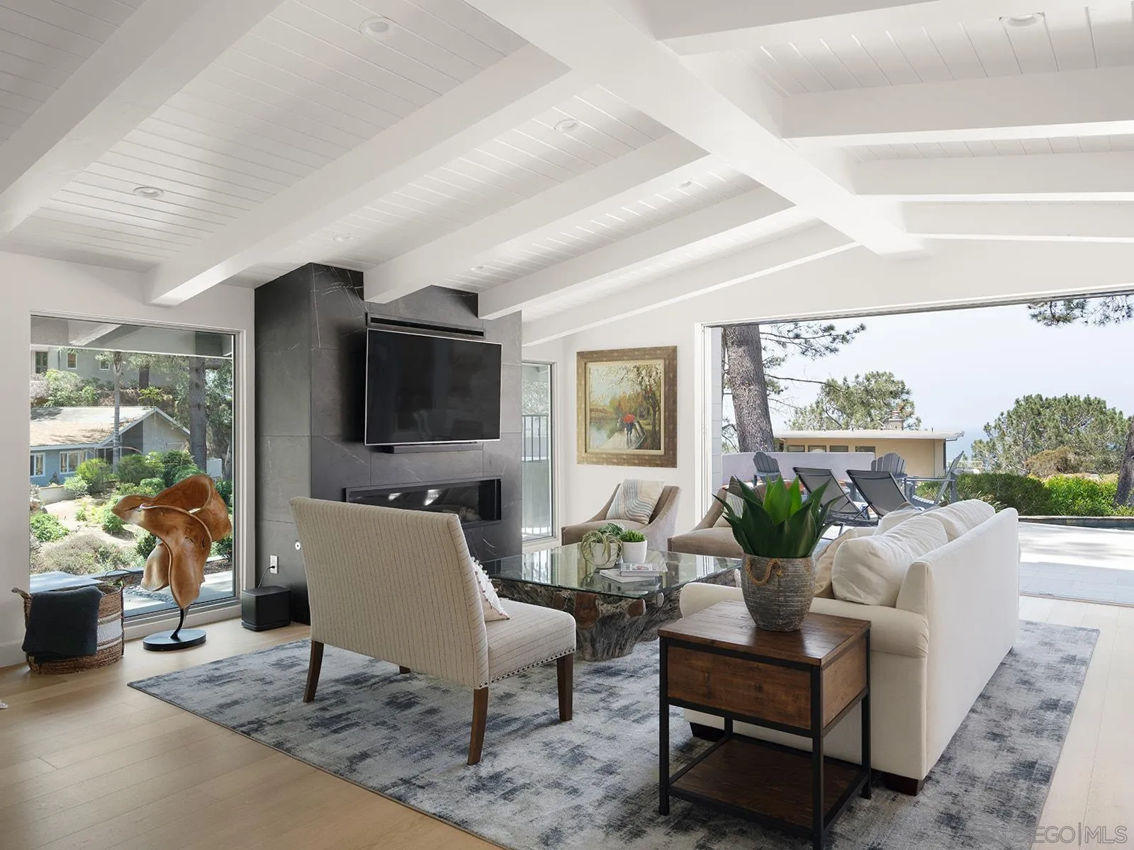 390 Hidden Pines Road Del Mar, CA 92014 - Photo 6 of 46 a living room with furniture a flat screen tv and a large window