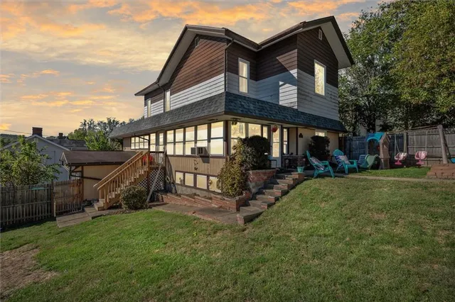 a view of a house with a yard and a deck