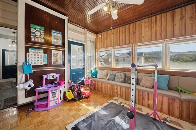 a bedroom with furniture and a large window