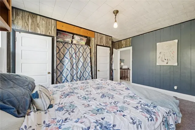 a bedroom with a large bed and a chandelier
