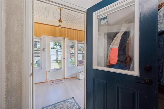 a view of a small space with wooden floor and a window