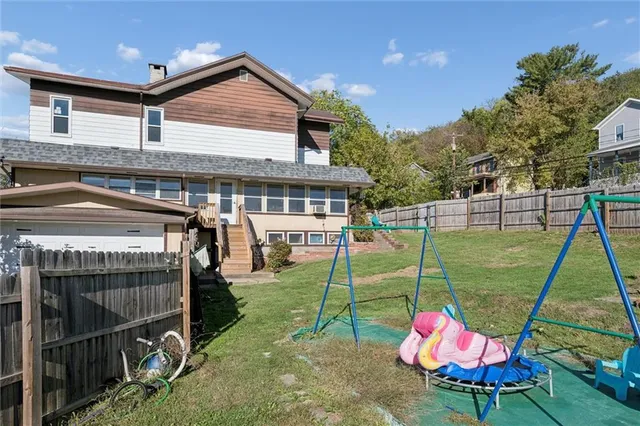 a view of a house with a backyard