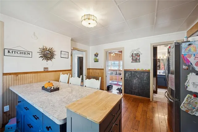a view of kitchen island with granite countertop furniture and wooden floor