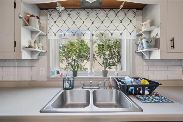 a kitchen counter with a sink and a window