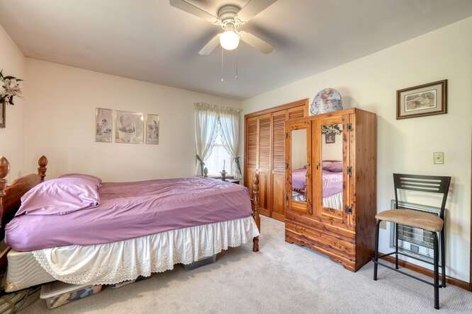 243 Allison Road Blairsville, GA 30512 - Photo 12 of 33 a bedroom with a bed and a chandelier