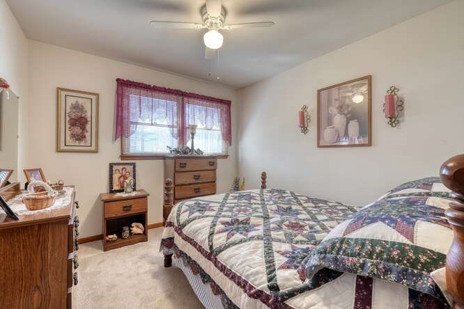243 Allison Road Blairsville, GA 30512 - Photo 16 of 33 a bedroom with a bed and a chandelier