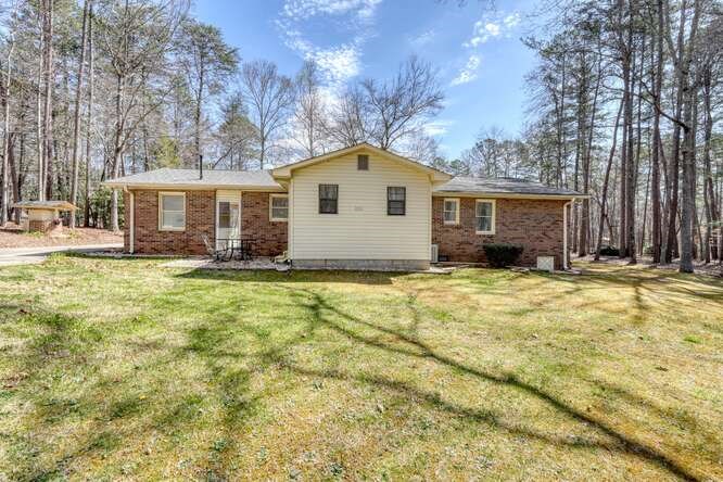 243 Allison Road Blairsville, GA 30512 - Photo 29 of 33 a house view with wooden fence and large trees