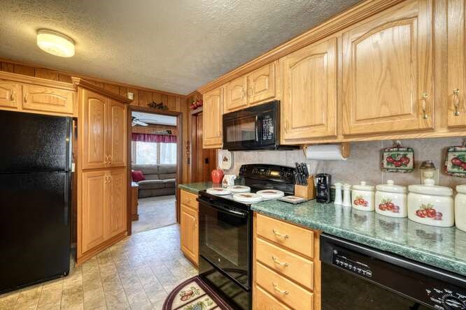 243 Allison Road Blairsville, GA 30512 - Photo 7 of 33 a kitchen with granite countertop a stove a sink and a microwave