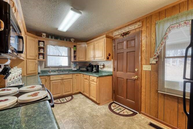 243 Allison Road Blairsville, GA 30512 - Photo 8 of 33 a kitchen with stainless steel appliances granite countertop sink refrigerator and window