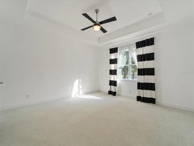 an empty room with closet and windows