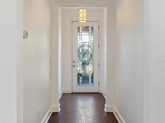 a view of an entryway with wooden floor and a window