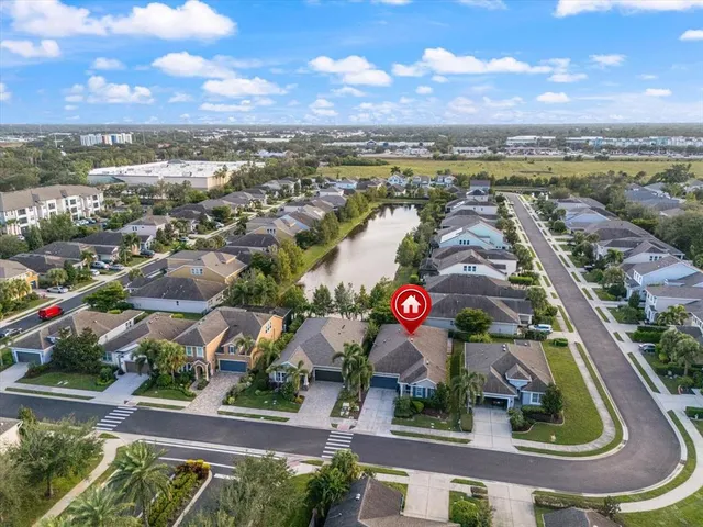 an aerial view of residential building and lake