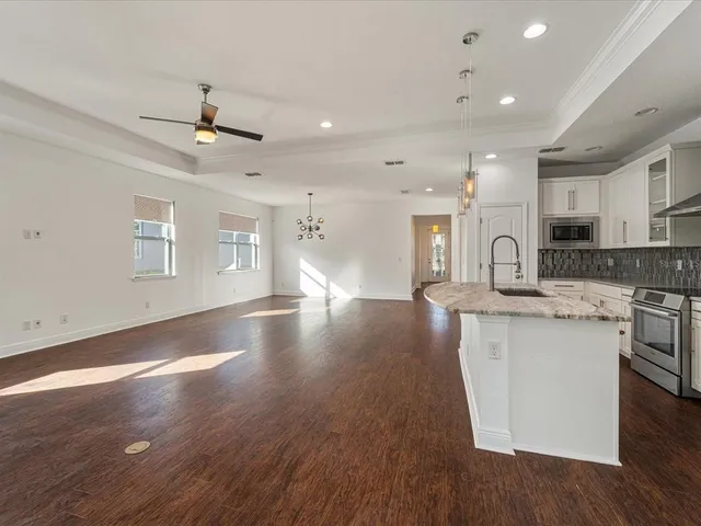 a view of kitchen with sink and wooden floor