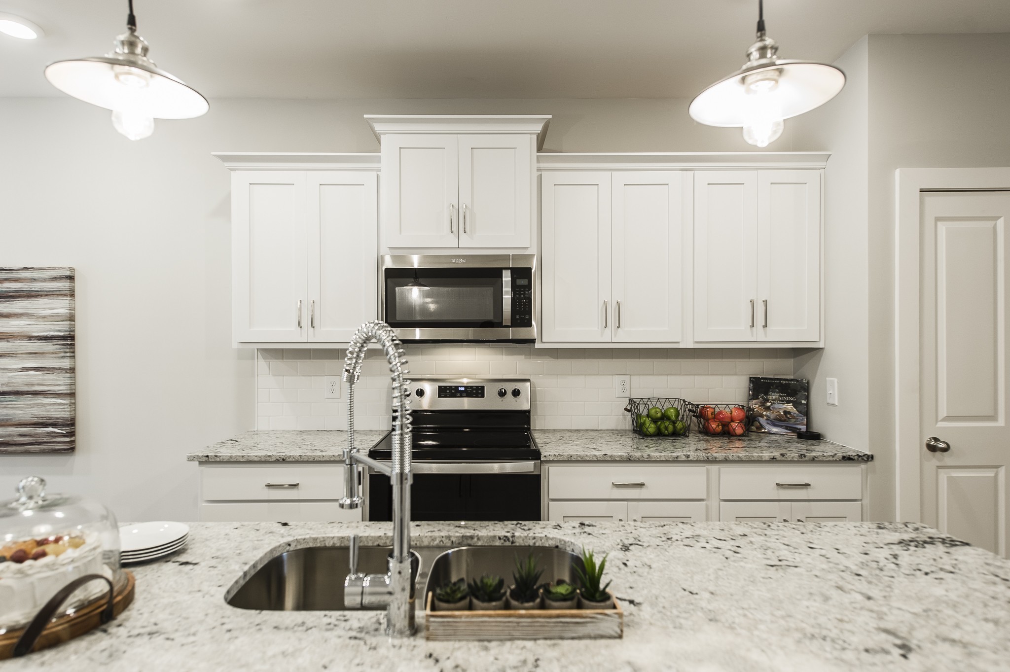 1144 Lock 4 Road, Unit B2 Gallatin, TN 37066 - Photo 6 of 17 a kitchen with stainless steel appliances kitchen island granite countertop a sink and a stove