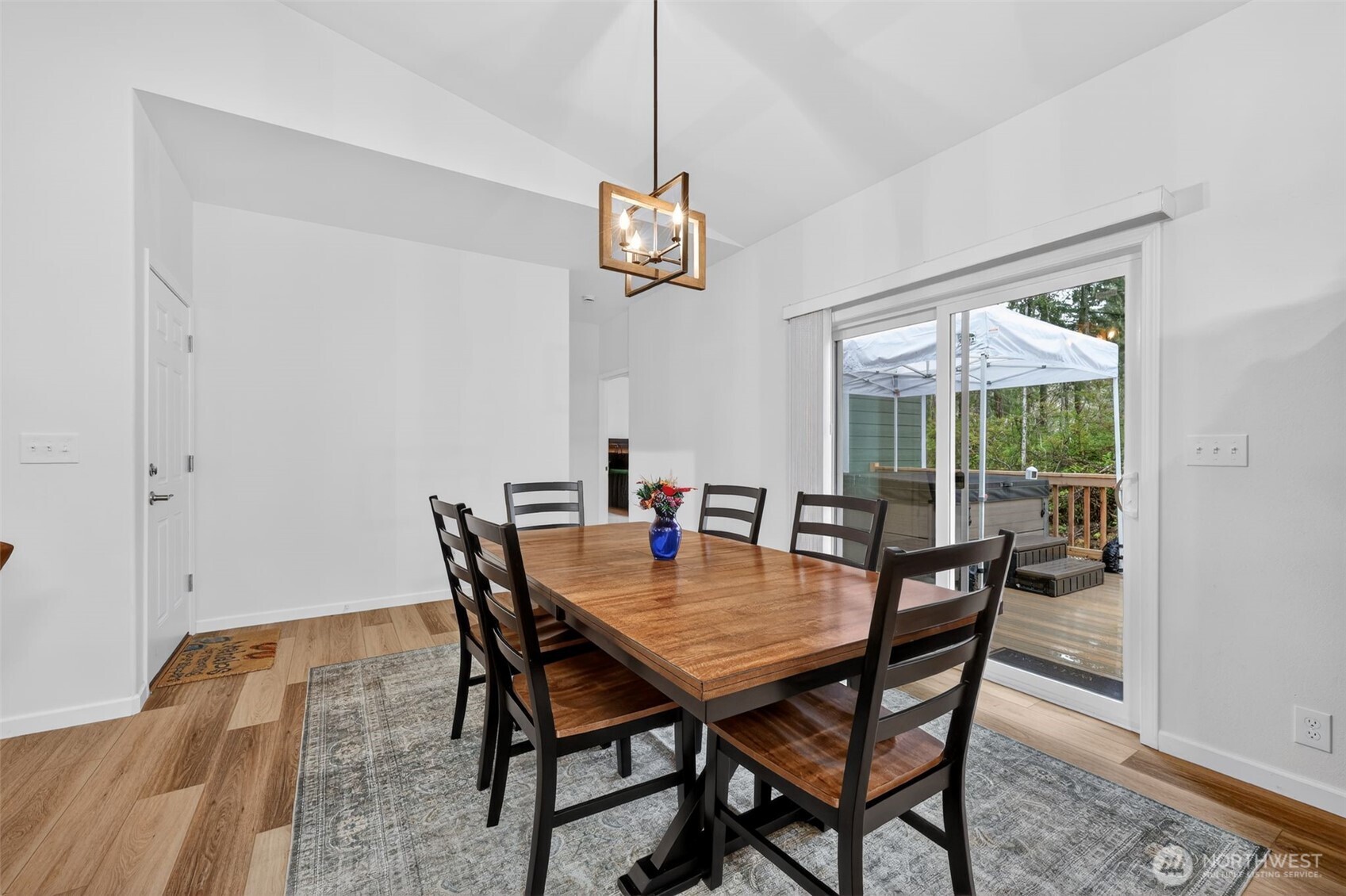 148 East Fox Run Lane Grapeview, WA 98546 - Photo 13 of 32 a dining room with furniture a chandelier and wooden floor