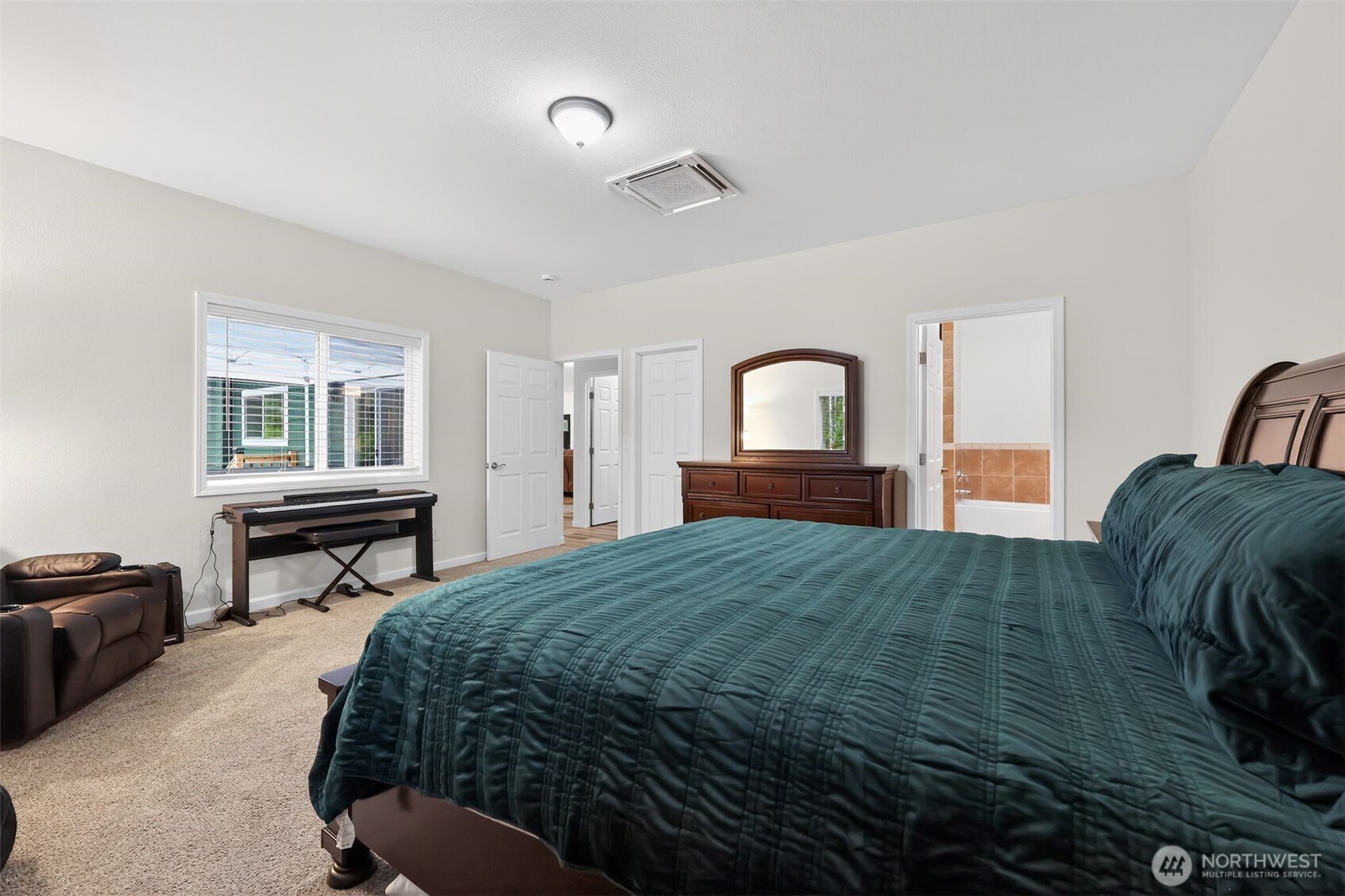 148 East Fox Run Lane Grapeview, WA 98546 - Photo 16 of 32 a bedroom with a bed and a dresser with mirror