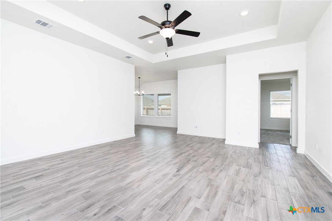 1418 Cedar Lane Temple, TX 76502 - Photo 2 of 9 an empty room with wooden floor and a ceiling fan