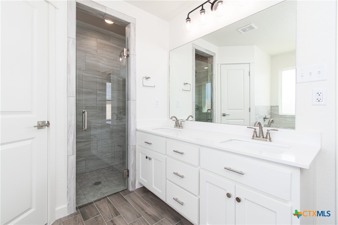 1418 Cedar Lane Temple, TX 76502 - Photo 6 of 9 a bathroom with a double vanity sink mirror and shower