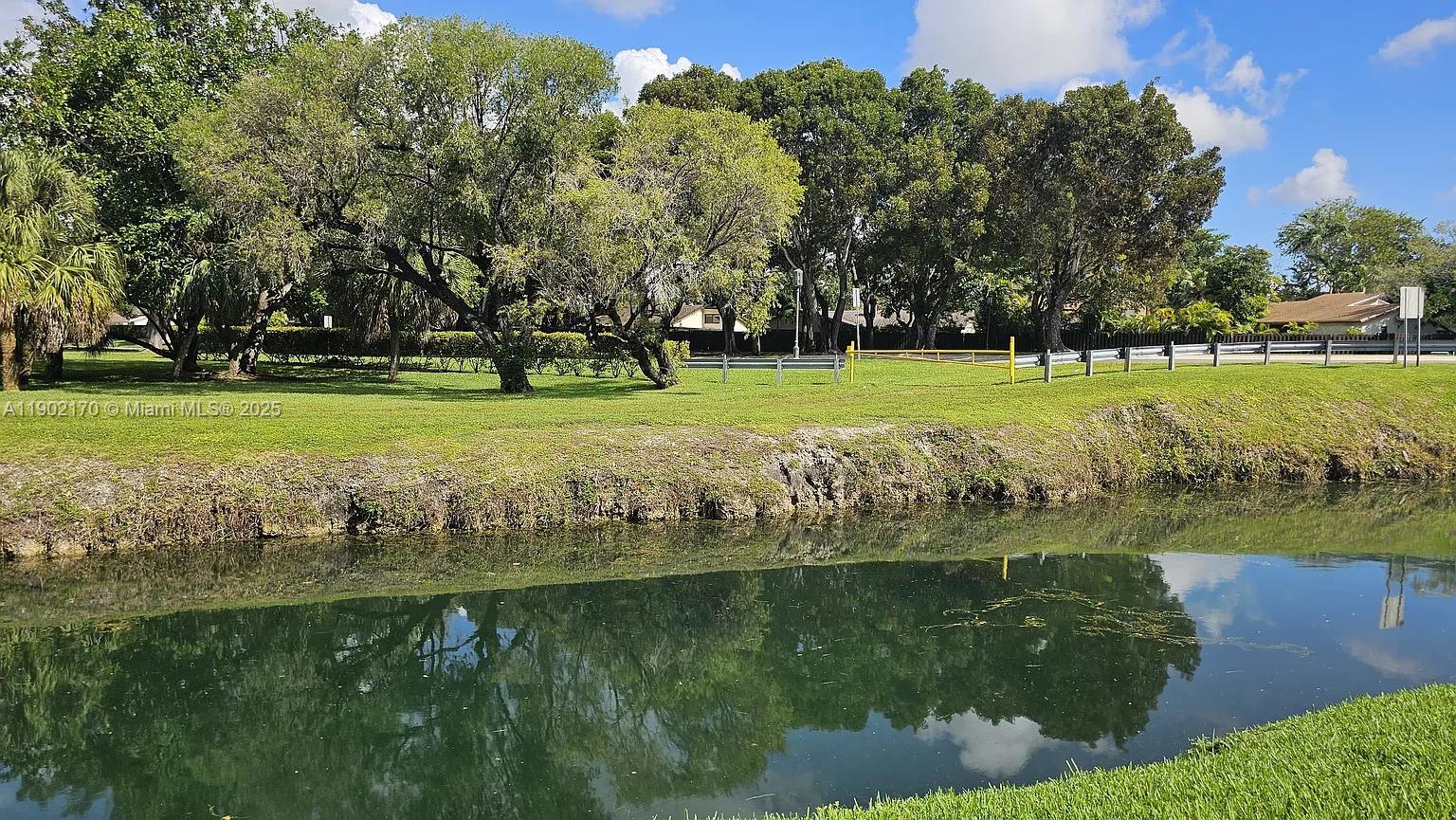 13235 Southwest 110th Terrace, Unit 183 Miami, FL 33186 - Photo 14 of 14 a view of a golf course with a lake