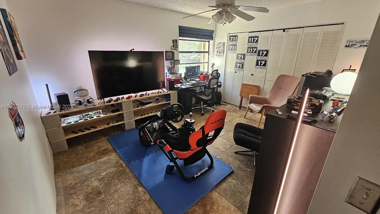 13235 Southwest 110th Terrace, Unit 183 Miami, FL 33186 - Photo 7 of 14 a living room with furniture and a flat screen tv