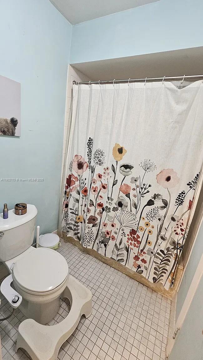 13235 Southwest 110th Terrace, Unit 183 Miami, FL 33186 - Photo 10 of 14 a white toilet sitting next to a shower curtain