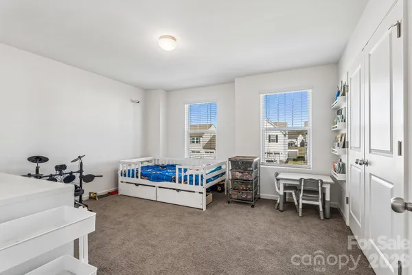 a bedroom with furniture and a window