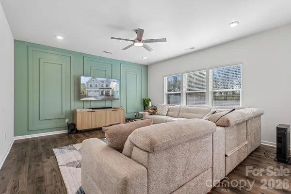 a bedroom with furniture and a large window