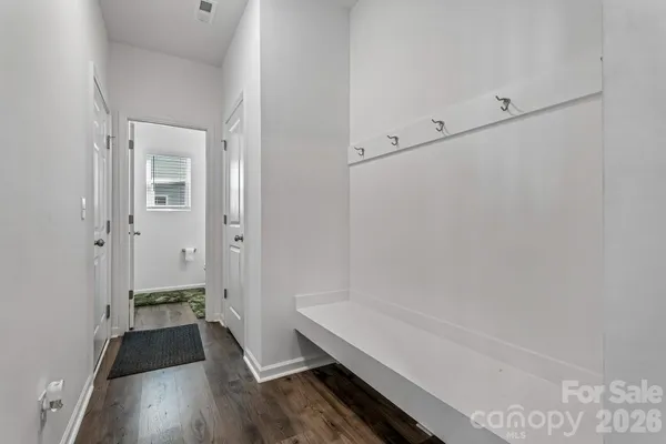 a view of a room with wooden floor