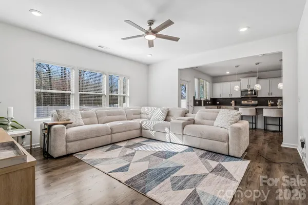 a living room with furniture and kitchen view