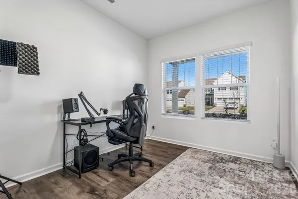a workspace with wooden floor and a window