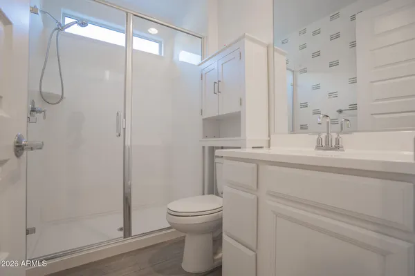 an empty room with closet and windows