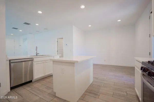 a large white kitchen with a sink