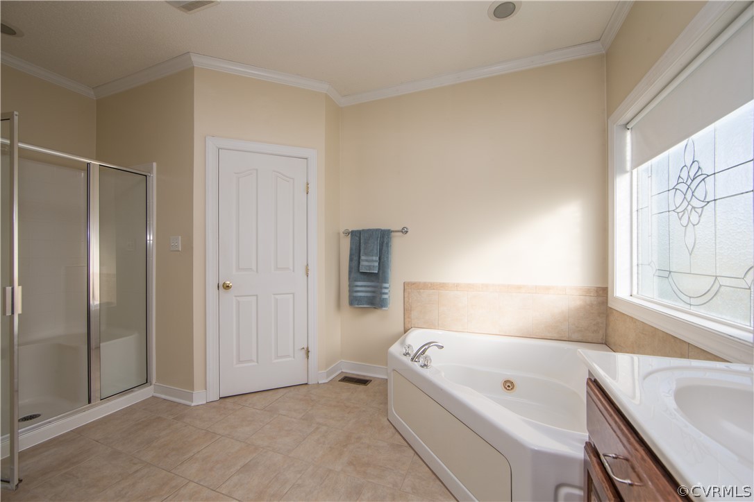 16840 Loving Union Road Disputanta, VA 23842 - Photo 15 of 35 a bathroom with a tub a sink and a window