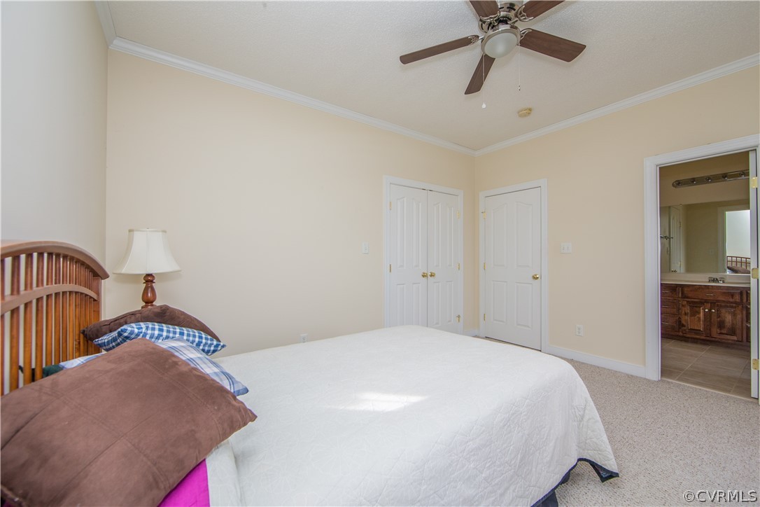 16840 Loving Union Road Disputanta, VA 23842 - Photo 17 of 35 a bedroom with a bed and a chandelier