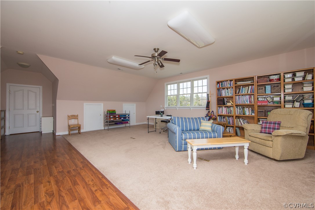 16840 Loving Union Road Disputanta, VA 23842 - Photo 23 of 35 a living room with furniture and a book shelf