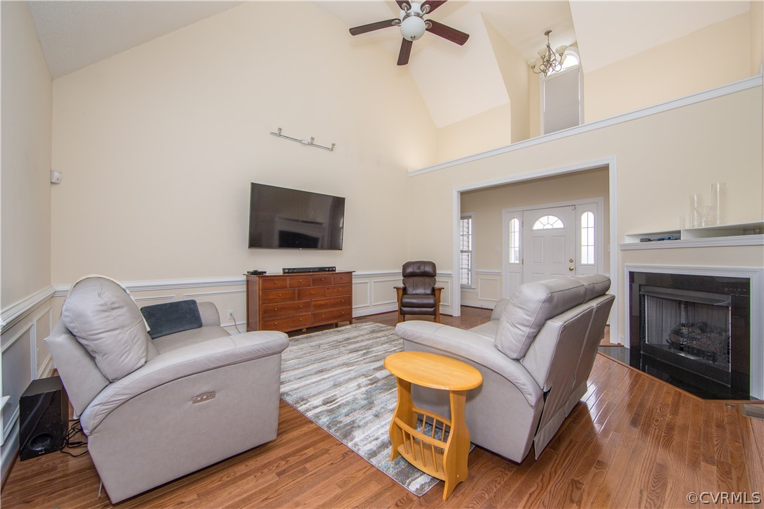 16840 Loving Union Road Disputanta, VA 23842 - Photo 6 of 35 a living room with furniture a fireplace and a flat screen tv