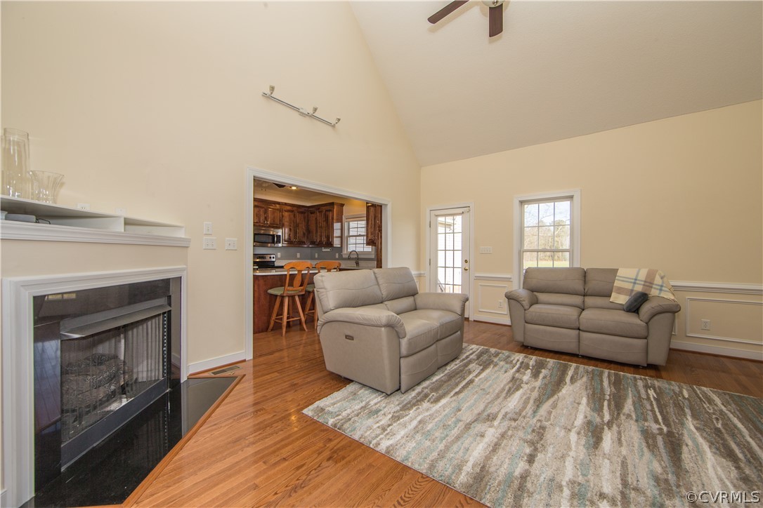 16840 Loving Union Road Disputanta, VA 23842 - Photo 7 of 35 a living room with furniture a fireplace and a flat screen tv