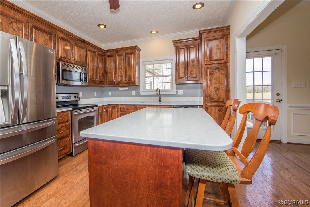 16840 Loving Union Road Disputanta, VA 23842 - Photo 10 of 35 a kitchen with stainless steel appliances granite countertop a refrigerator a sink dishwasher a stove and white countertops with wooden floor