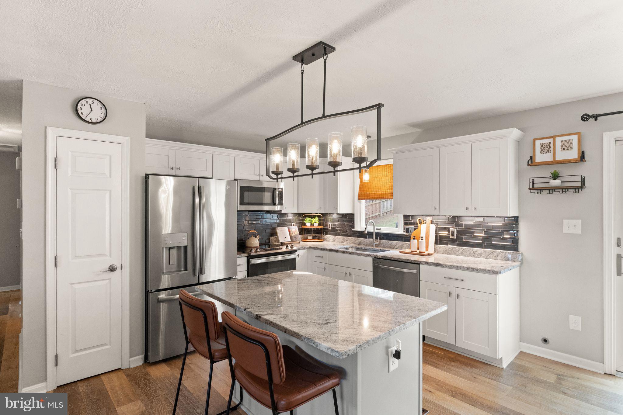413 George Street Winchester, VA 22601 - Photo 12 of 54 a kitchen with refrigerator cabinets dining table and chairs