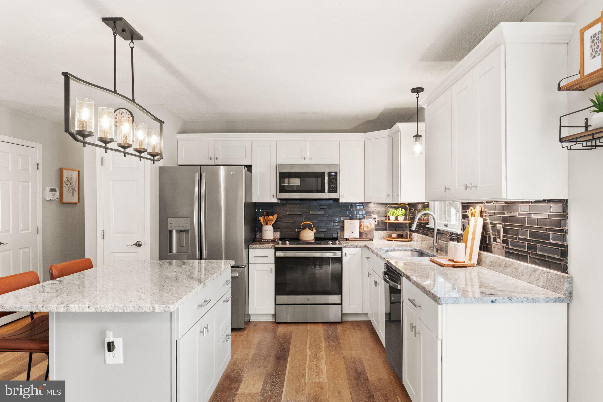 413 George Street Winchester, VA 22601 - Photo 15 of 54 a kitchen with stainless steel appliances a sink stove refrigerator and cabinets