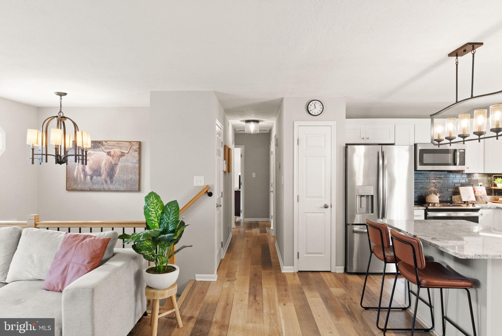 413 George Street Winchester, VA 22601 - Photo 17 of 54 a view of a hallway with dining room and wooden floor