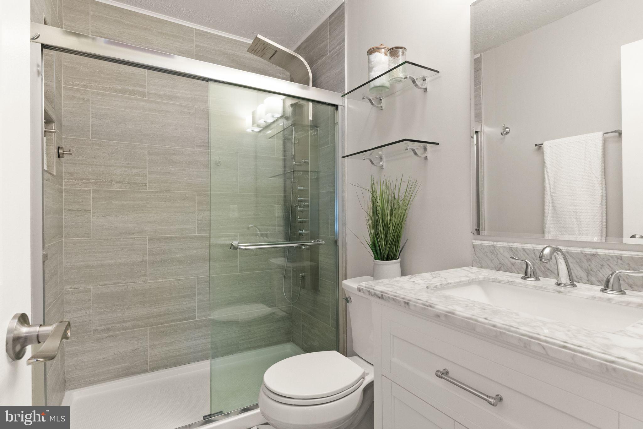 413 George Street Winchester, VA 22601 - Photo 22 of 54 a bathroom with a granite countertop sink toilet and shower