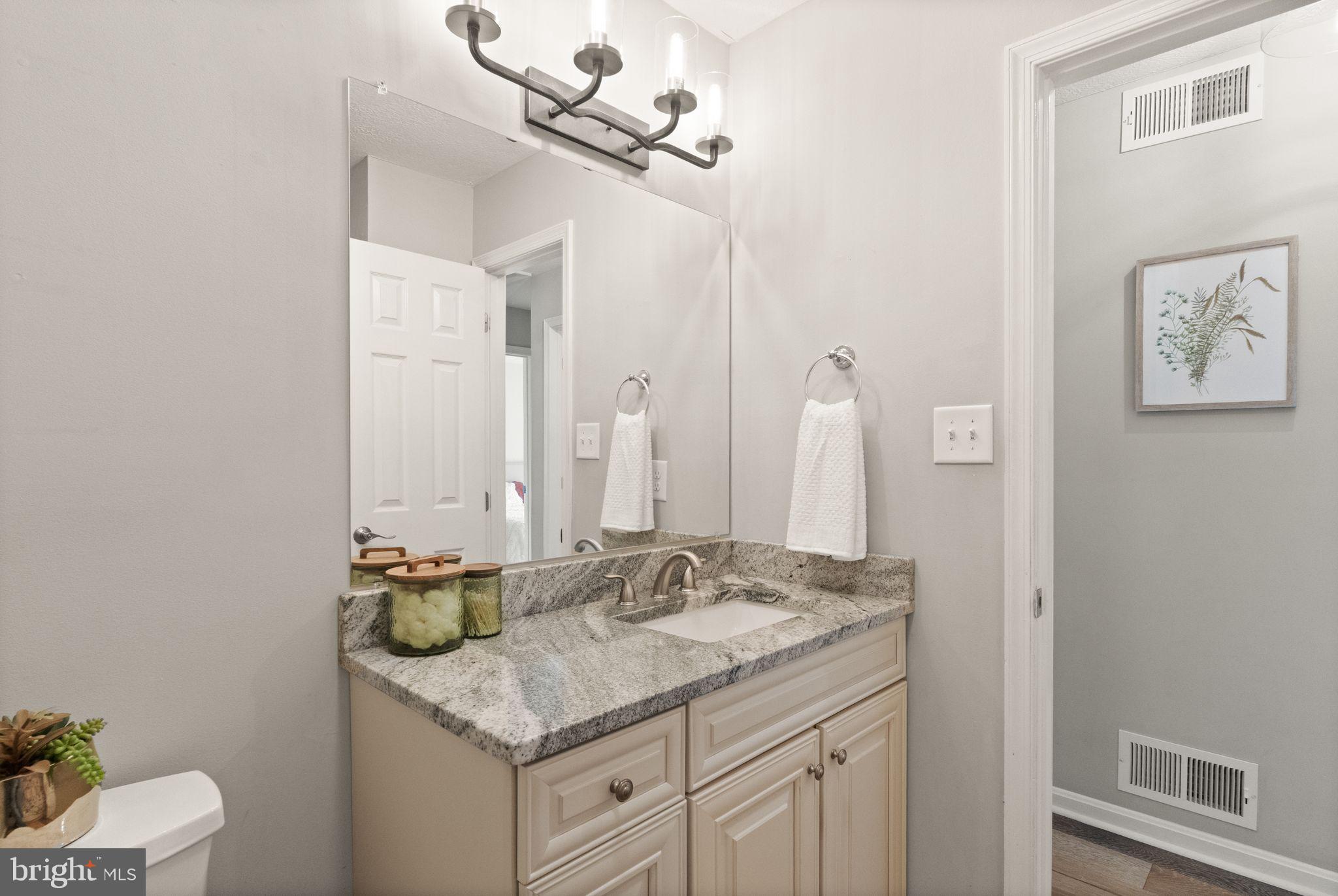 413 George Street Winchester, VA 22601 - Photo 29 of 54 a bathroom with a granite countertop sink and a mirror