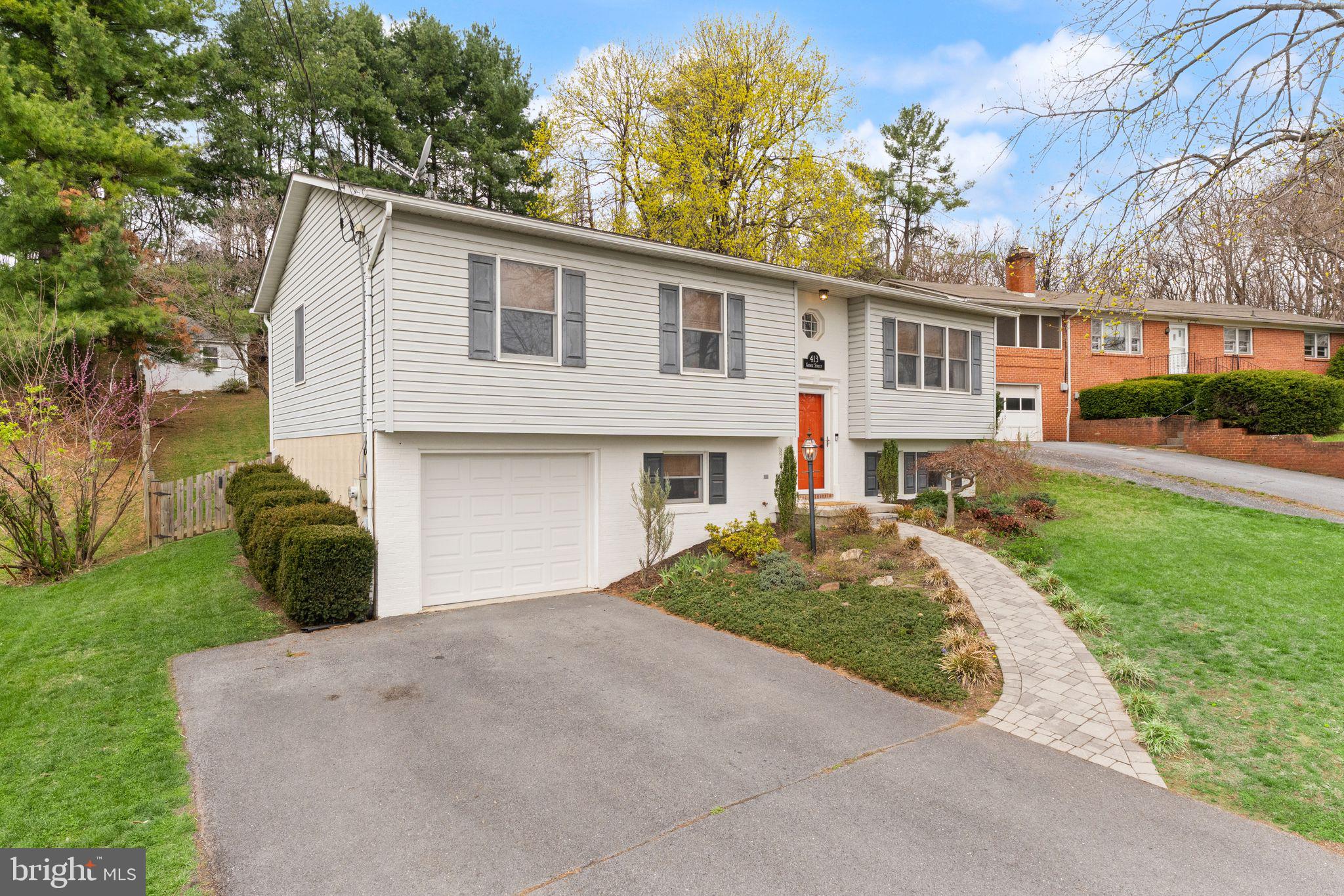 413 George Street Winchester, VA 22601 - Photo 3 of 54 a front view of a house with a yard and garage