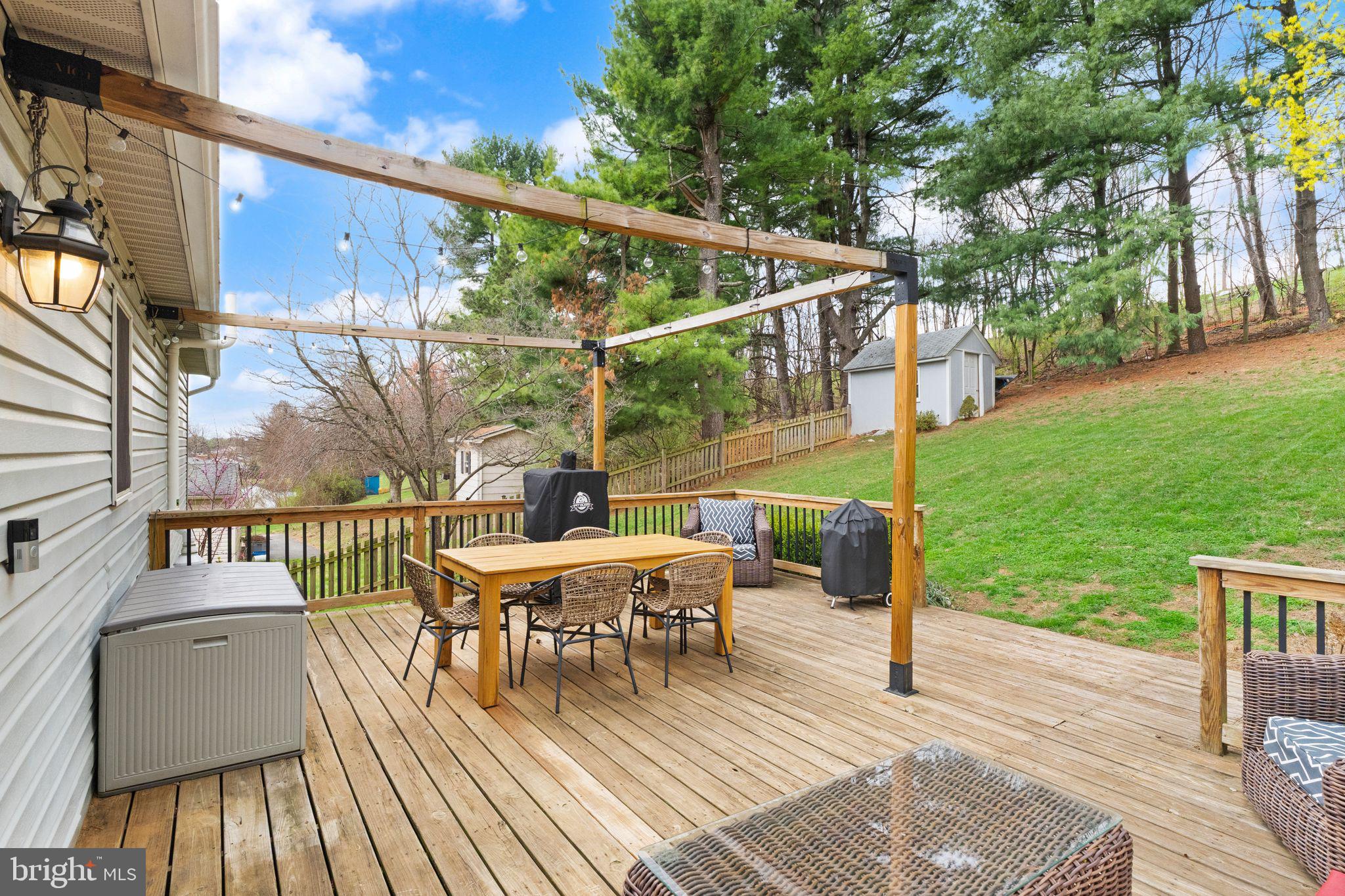 413 George Street Winchester, VA 22601 - Photo 40 of 54 a view of a deck with table and chairs and wooden floor